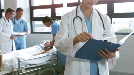 Doctor-holding-reports-with-patient-and-surgeon-in-background
