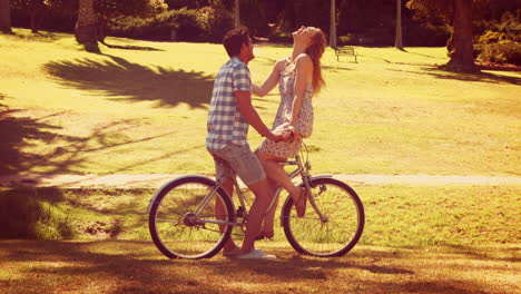 Linda-Pareja-En-Un-Paseo-En-Bicicleta-Por-El-Parque