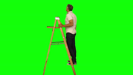 Casual-man-standing-on-ladder