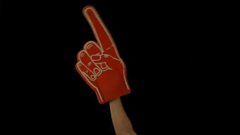 Supporter-holds-a-foam-hand-up-in-air