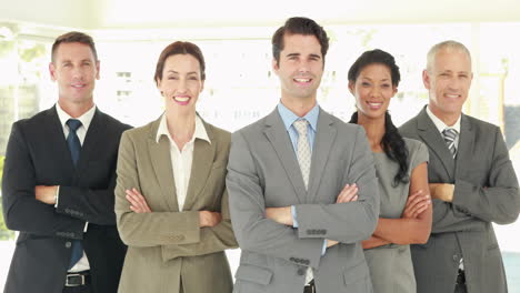 Smiling-business-people-looking-at-camera-with-arms-crossed