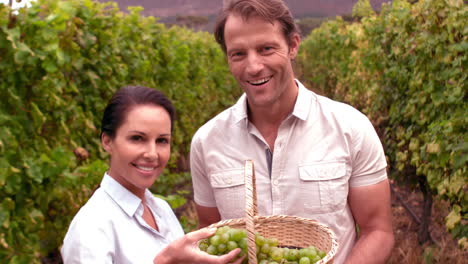 Smiling-couple-holding-grapes-in-slow-motion