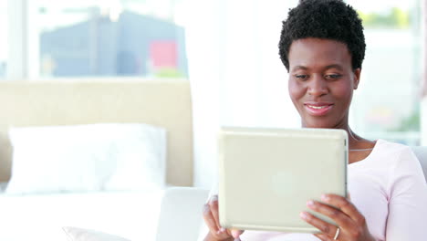 Happy-couple-using-tablet-and-reading-book