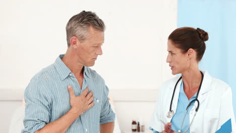 Two-doctors-speaking-together-and-looking-at-clipboard