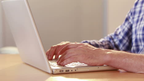 Close-up-view-of-angry-casual-businessman-using-laptop