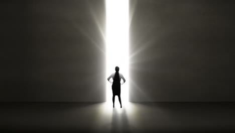 Businesswoman-looking-at-light-shining-through-opening