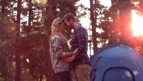 Couple-hugging-beside-their-tent