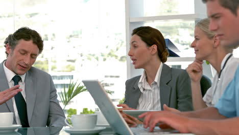 Doctors-speaking-with-business-team-during-meeting