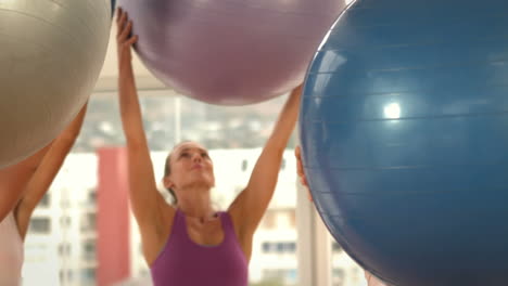 Fit-women-lifting-a-medicinal-ball