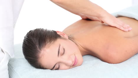 Attractive-woman-receiving-back-massage-at-spa-center