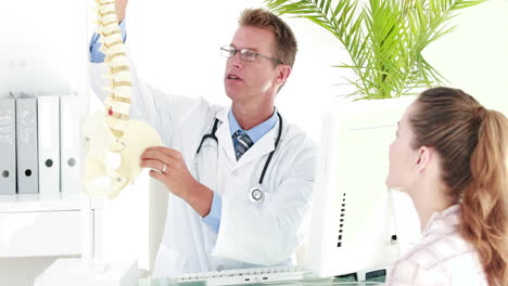 Physiotherapist-explaining-spine-model-to-patient