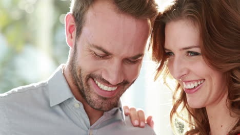 Smiling-couple-with-engagement-ring