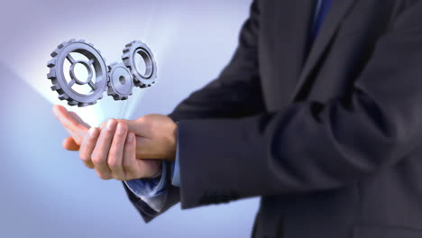 Businessman-presenting-cogs-and-wheels-graphic