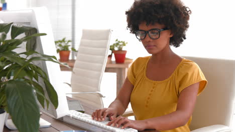 Serious-casual-businesswoman-using-computer