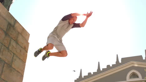 Young-man-jumping-from-wall-
