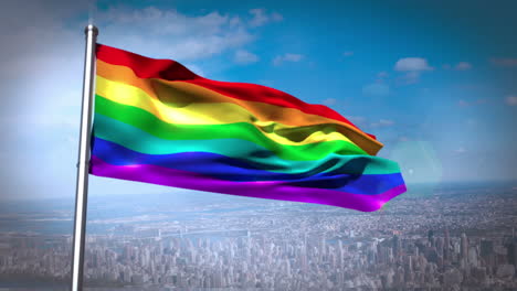 Rainbow-flag-blowing-above-city