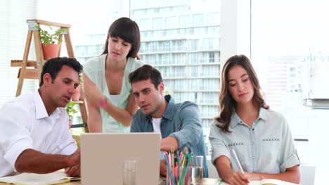 Casual-business-people-looking-at-laptop-computer-