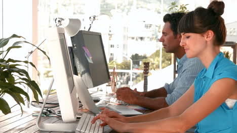 Creative-business-team-working-together-on-computer
