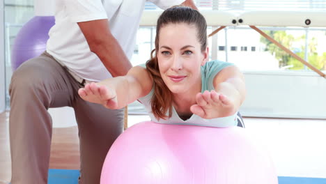 Physiotherapist-using-exercise-ball-with-patient