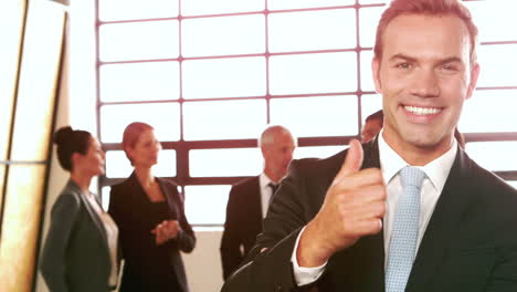 Smiling-businessman-with-thumbs-up-
