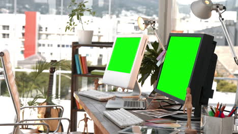 Desk-with-two-computers-and-laptop