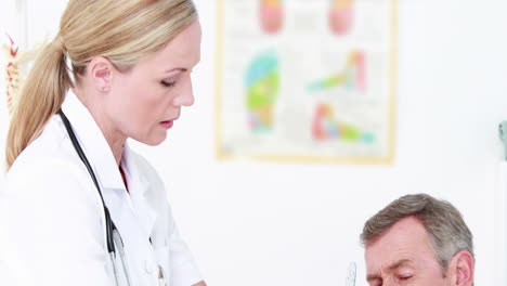 Doctor-examining-man-hand-with-tools