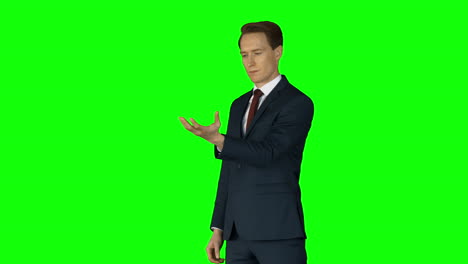 Businessman-lifting-something-on-his-hand-on-green-screen-