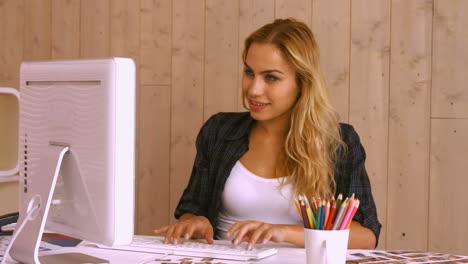 Pretty-worker-at-her-desk