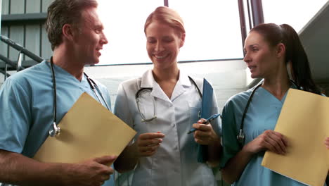 Smiling-medical-team-going-down-the-stairs-