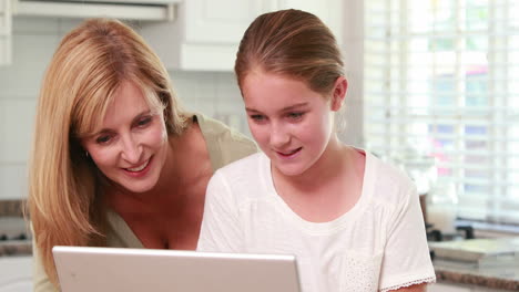 Mother-and-daughter-using-laptop-together
