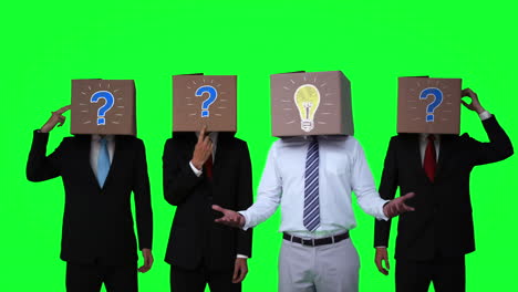 Team-of-businessman-hiding-head-with-box-and-gesturing