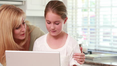 Mother-and-daughter-using-laptop-together