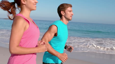 Couple-jogging-on-beach