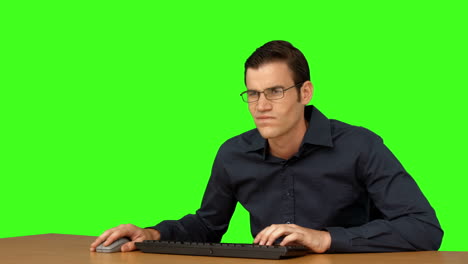 Businessman-typing-at-his-desk