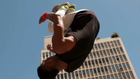 Handsome-young-man-doing-backflip-