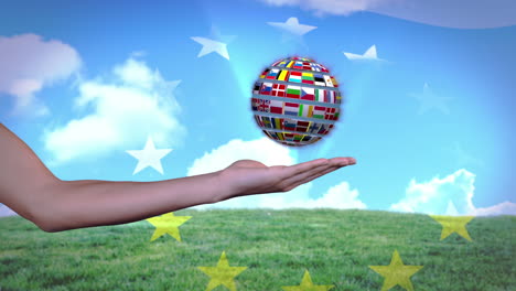 Ball-made-of-European-nationals-flags-turning-on-hands-