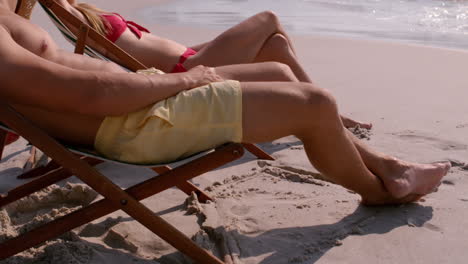 Cute-couple-tanning-together-in-the-deck-chair