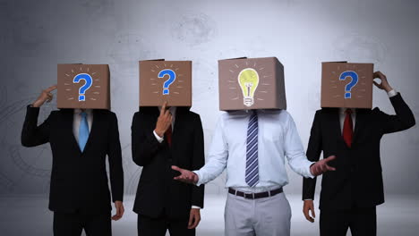 Team-of-businessman-hiding-head-with-box-and-gesturing