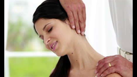 Smiling-woman-getting-a-neck-massage