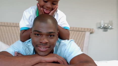 Father-and-son-posing-on-bed