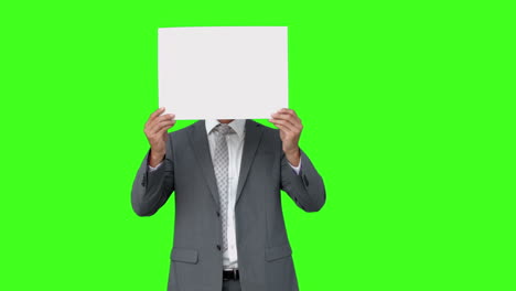 Businessman-standing-with-page-over-face