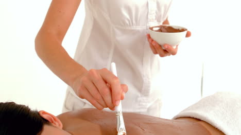 Beautiful-brunette-enjoying-a-chocolate-beauty-treatment