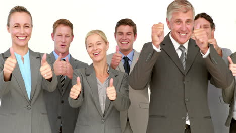 Business-people-looking-at-camera-with-thumbs-up