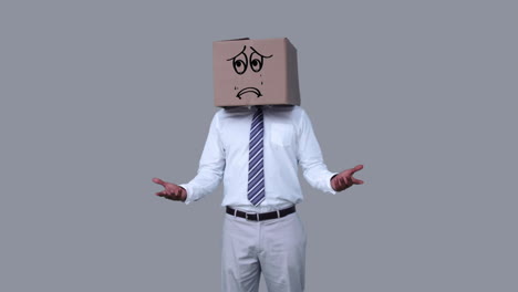 Businessman-hiding-head-with-sad-box