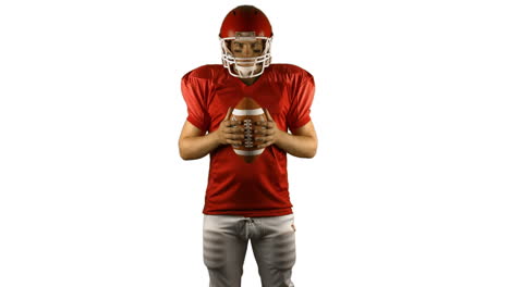 Red-american-football-player-holding-a-ball