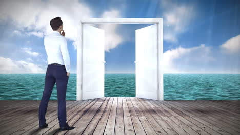 Door-opening-to-ocean-watched-by-businessman