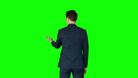 Businessman-lifting-something-on-his-hand-on-green-screen-