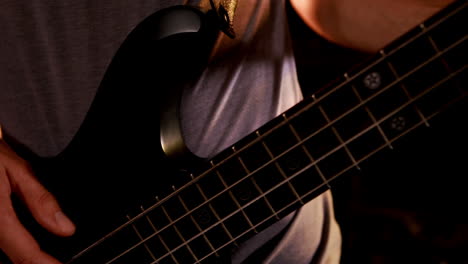 Close-up-of-man-playing-bass