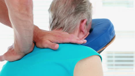 Physiotherapist-doing-back-massage-to-his-patient