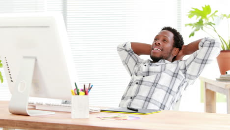 Casual-businessman-relaxing-in-his-swivel-chair